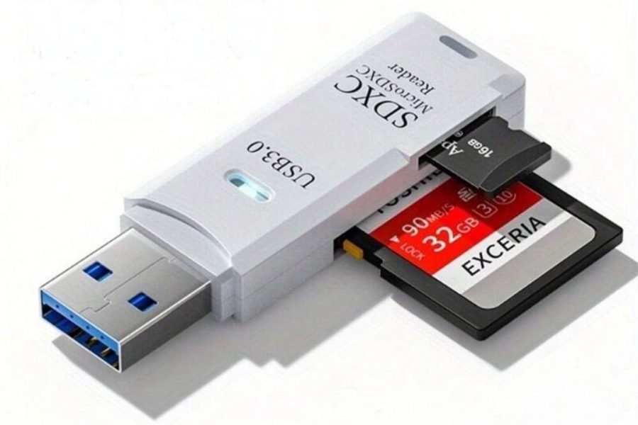 A white Exceria USB 3.0 SDXC card reader with an SD card labeled "Exceria 32GB" and a smaller microSD card labeled "ADATA 16GB" inserted into its slots.