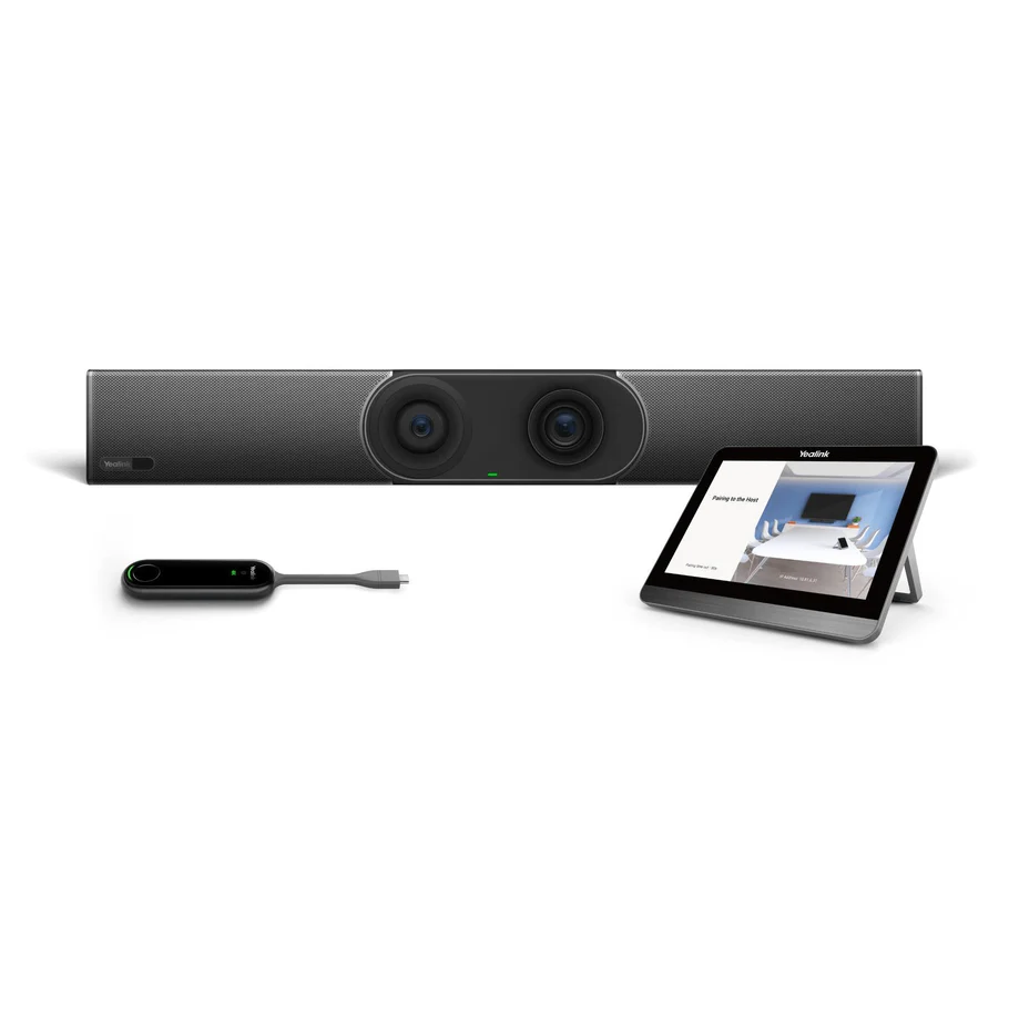 A video conferencing setup is presented against a white background. At the center, a long, horizontal video bar with two prominent camera lenses in the middle and speaker grilles on either side is positioned. The Yealink logo is visible on the far left of the video bar. To the right, a tablet with a black screen, displaying an image of a meeting room, is propped up on a stand. To the left, a sleek, black remote control with a glowing green indicator light and a short cable extends from its right side.